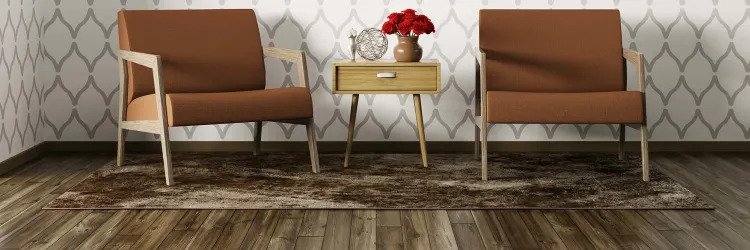 Two brown chairs and side table on area rug