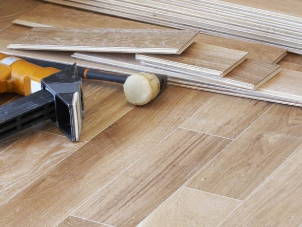 Wooden flooring planks on the floor with tools