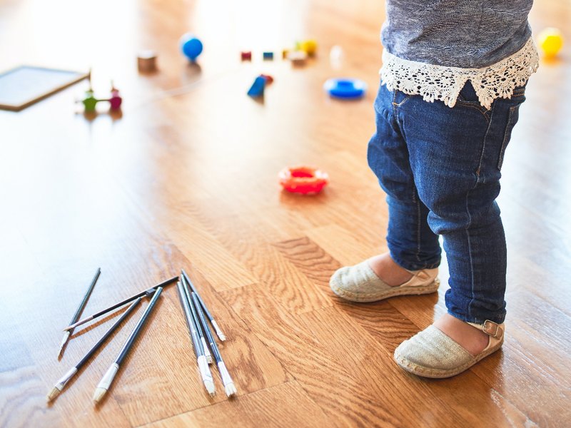 Child playing on laminate flooring
